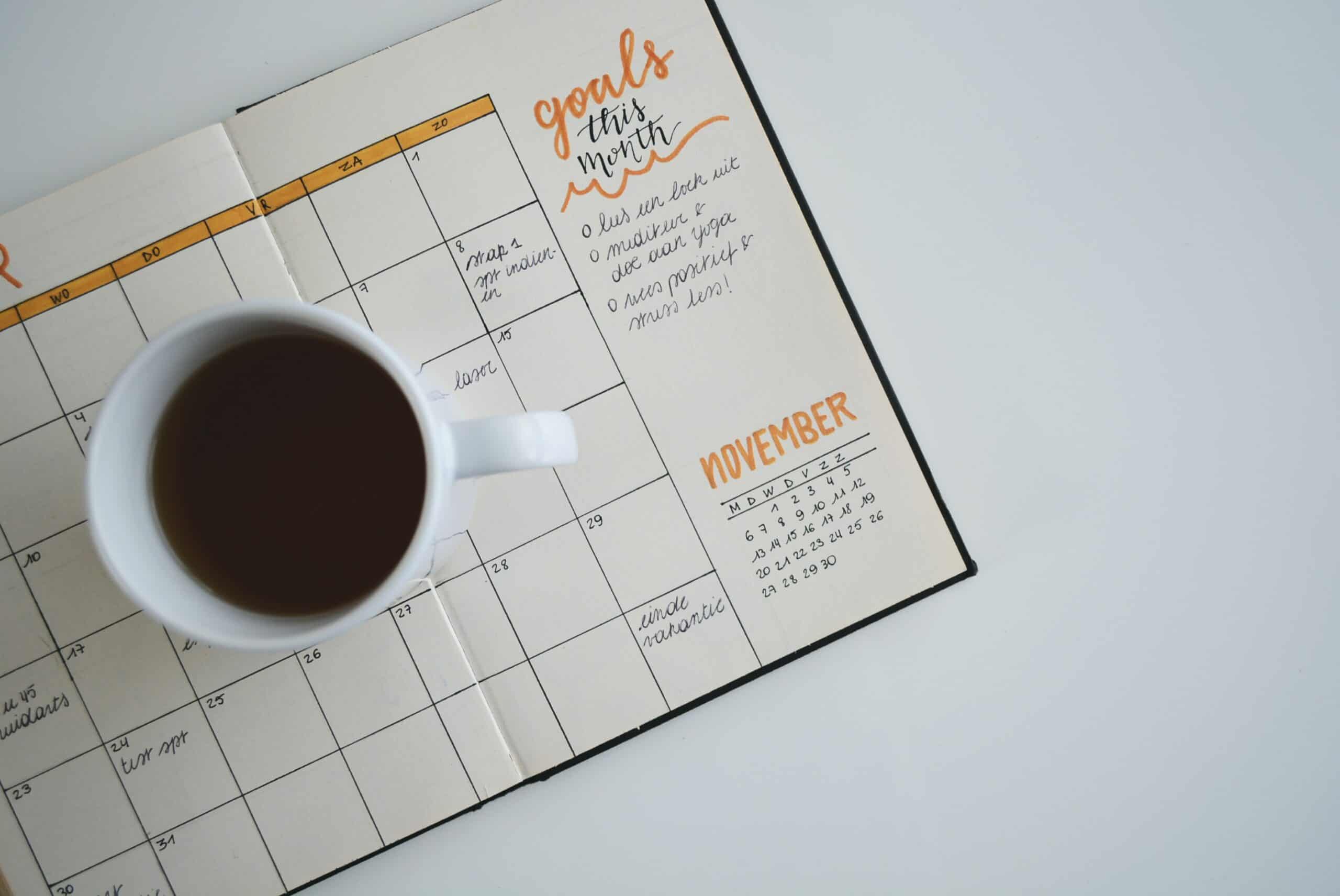 Cup of coffee sitting on a planner
