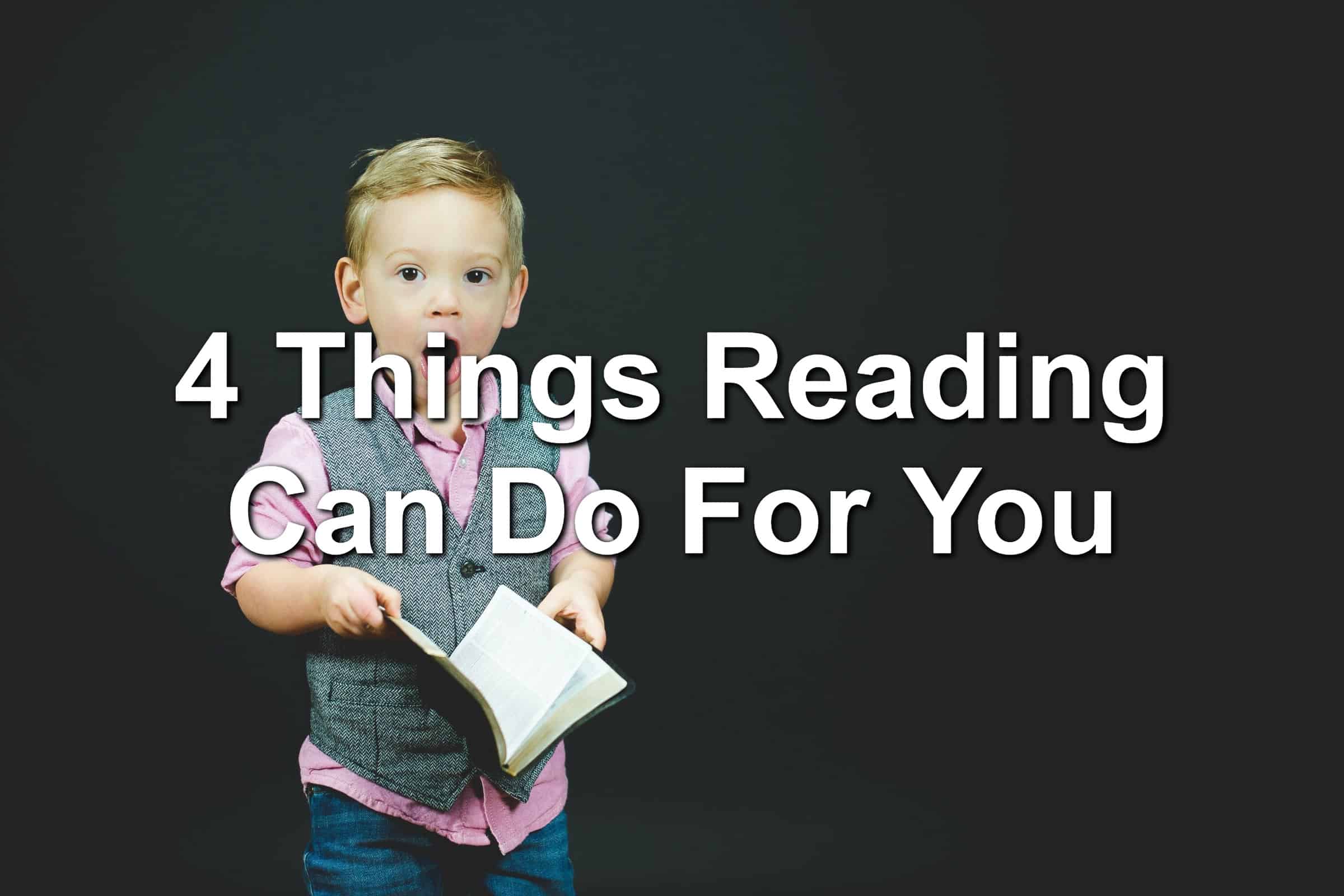 A boy in a vest holding a book. His mouth is open in shock or surprise