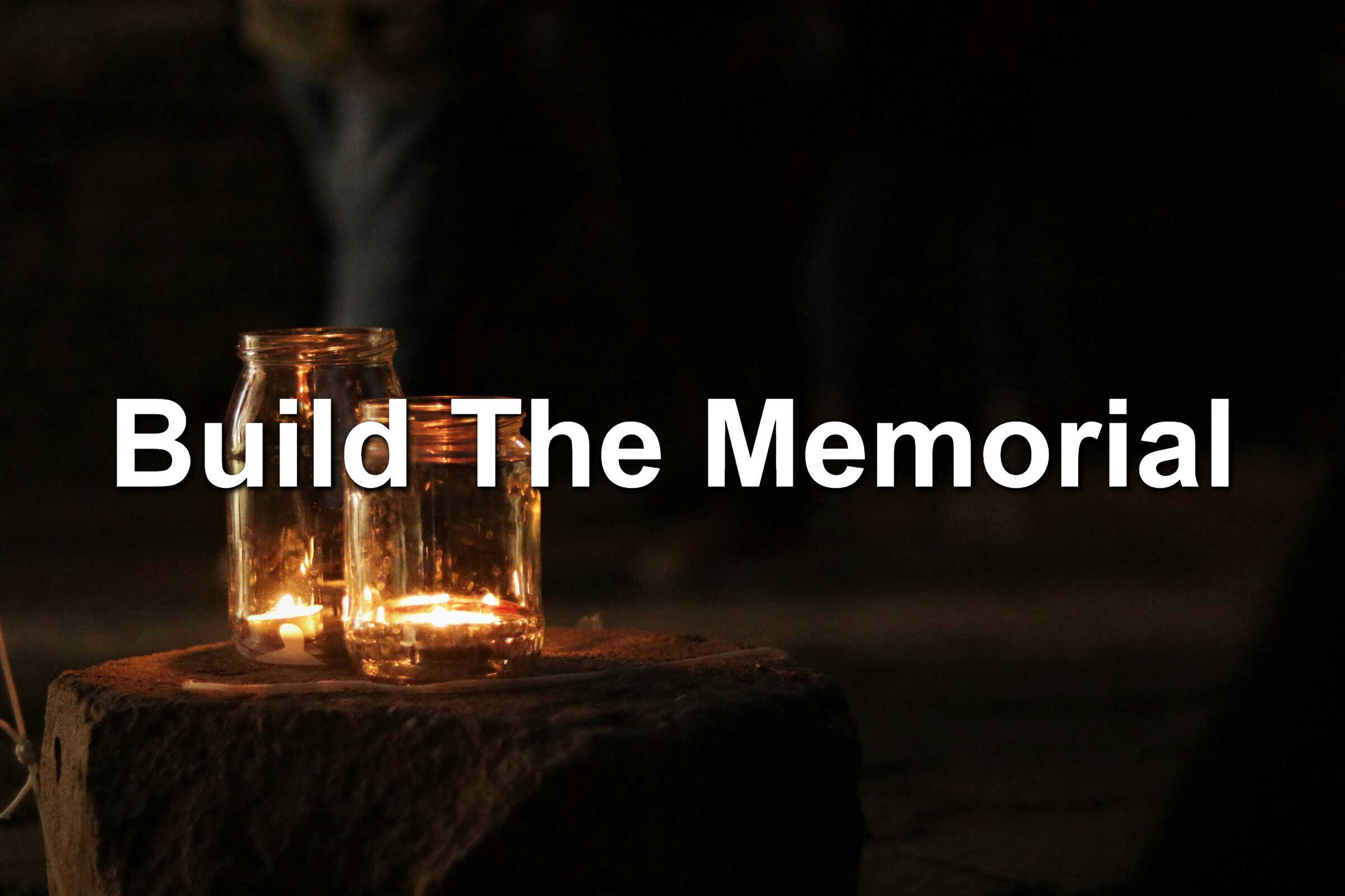 A candle memorial against a black background