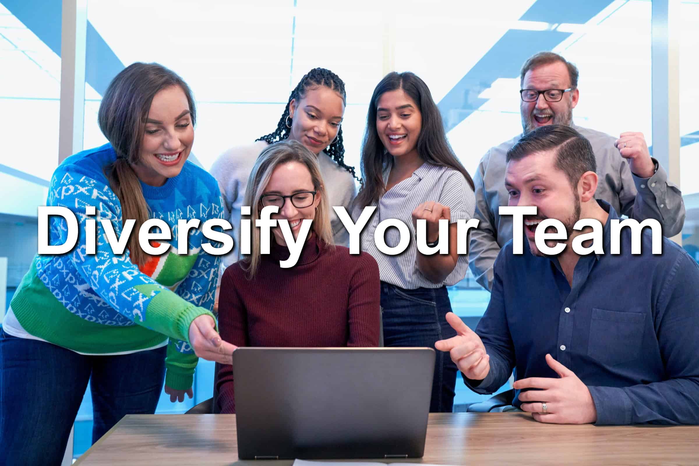 A group of people gathered around a laptop.