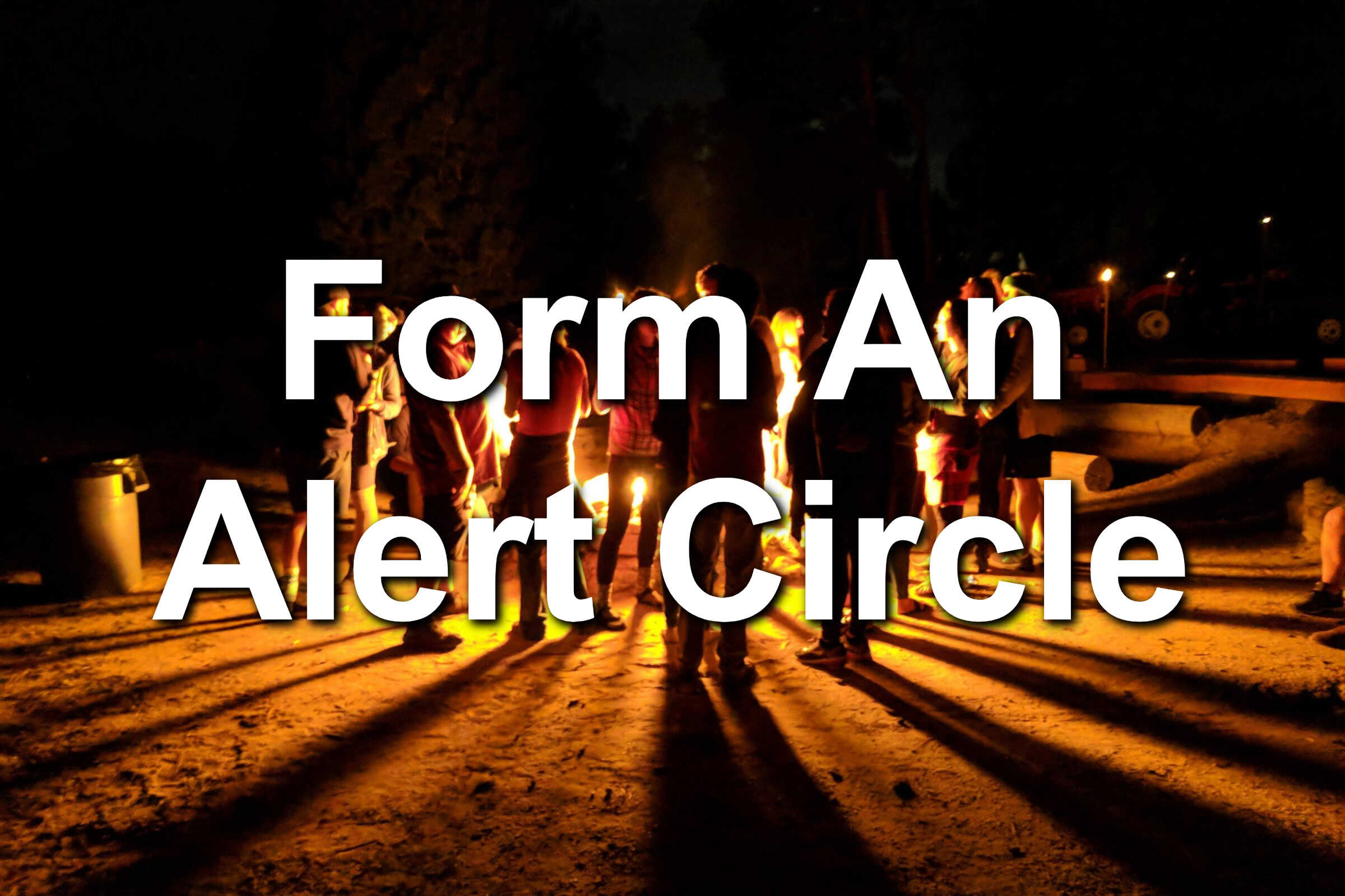 People gathered around a fire pit. They form a circle