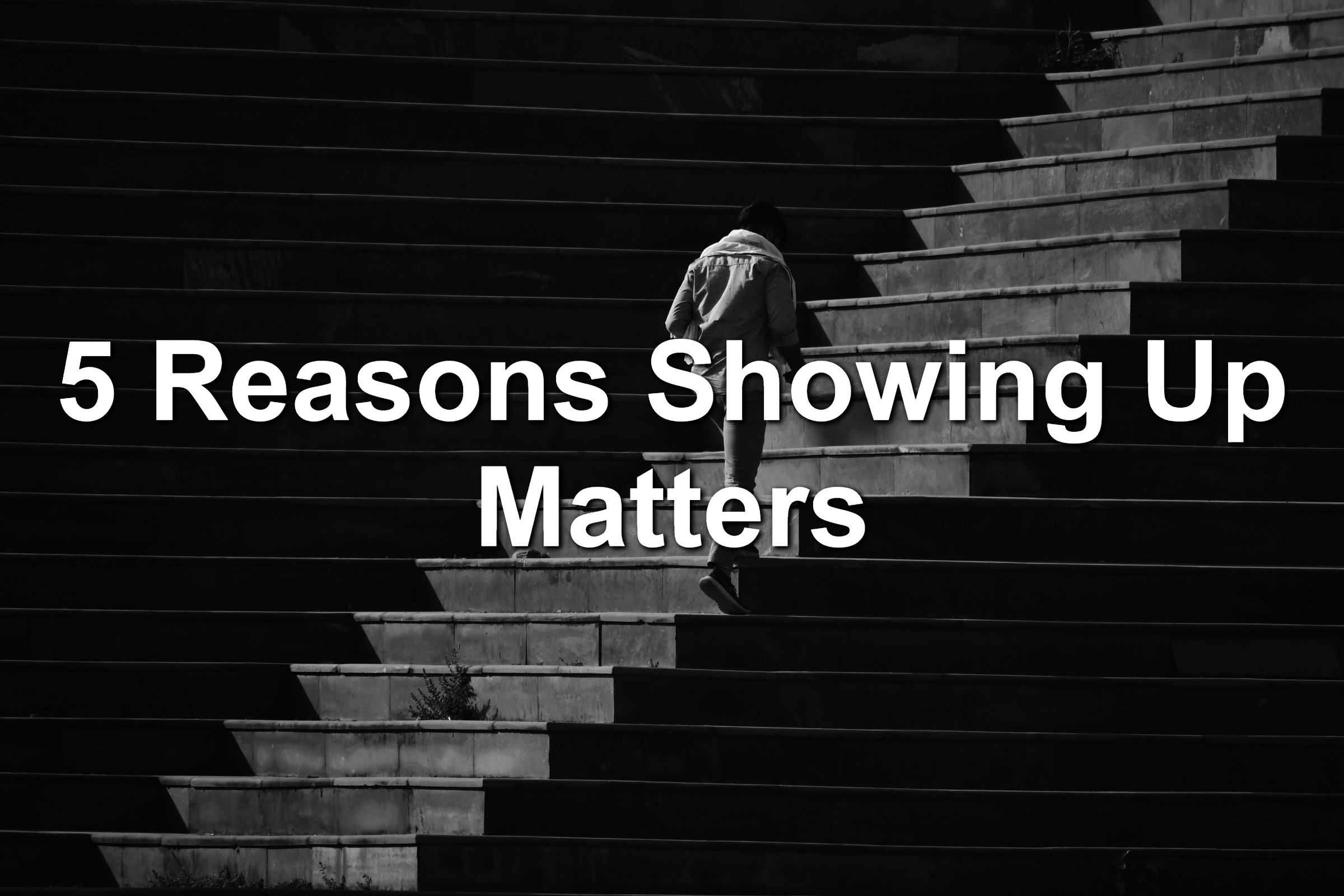 Man walking up a large set of stairs. Photo is black and white