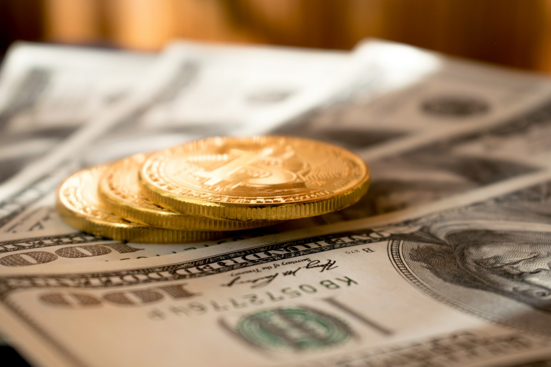 Paper money with gold coins on top.