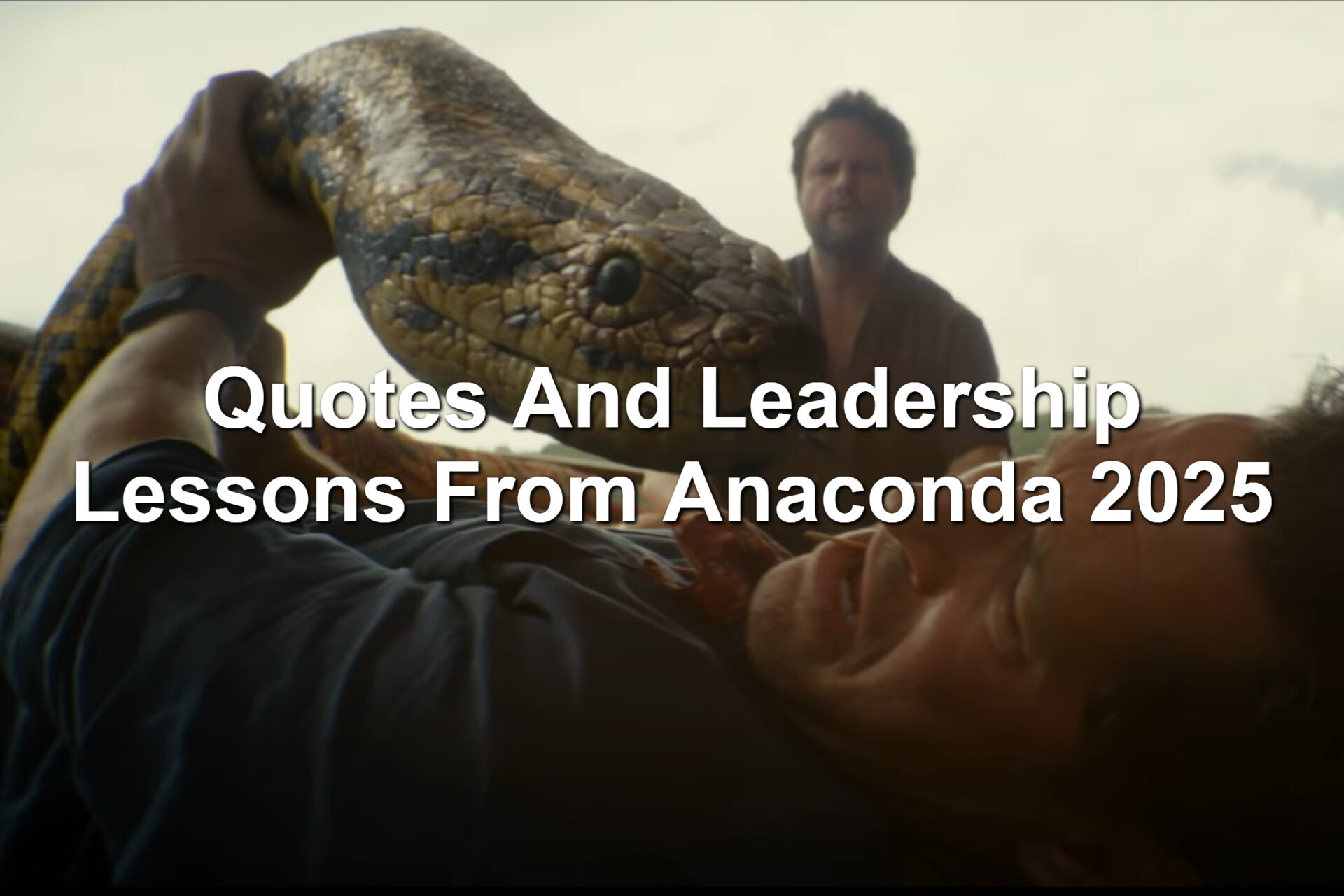 Man being held down by a giant snake. Scene from the 2025 Anaconda film. Paul Rudd's character is looking away from a giant snake.
