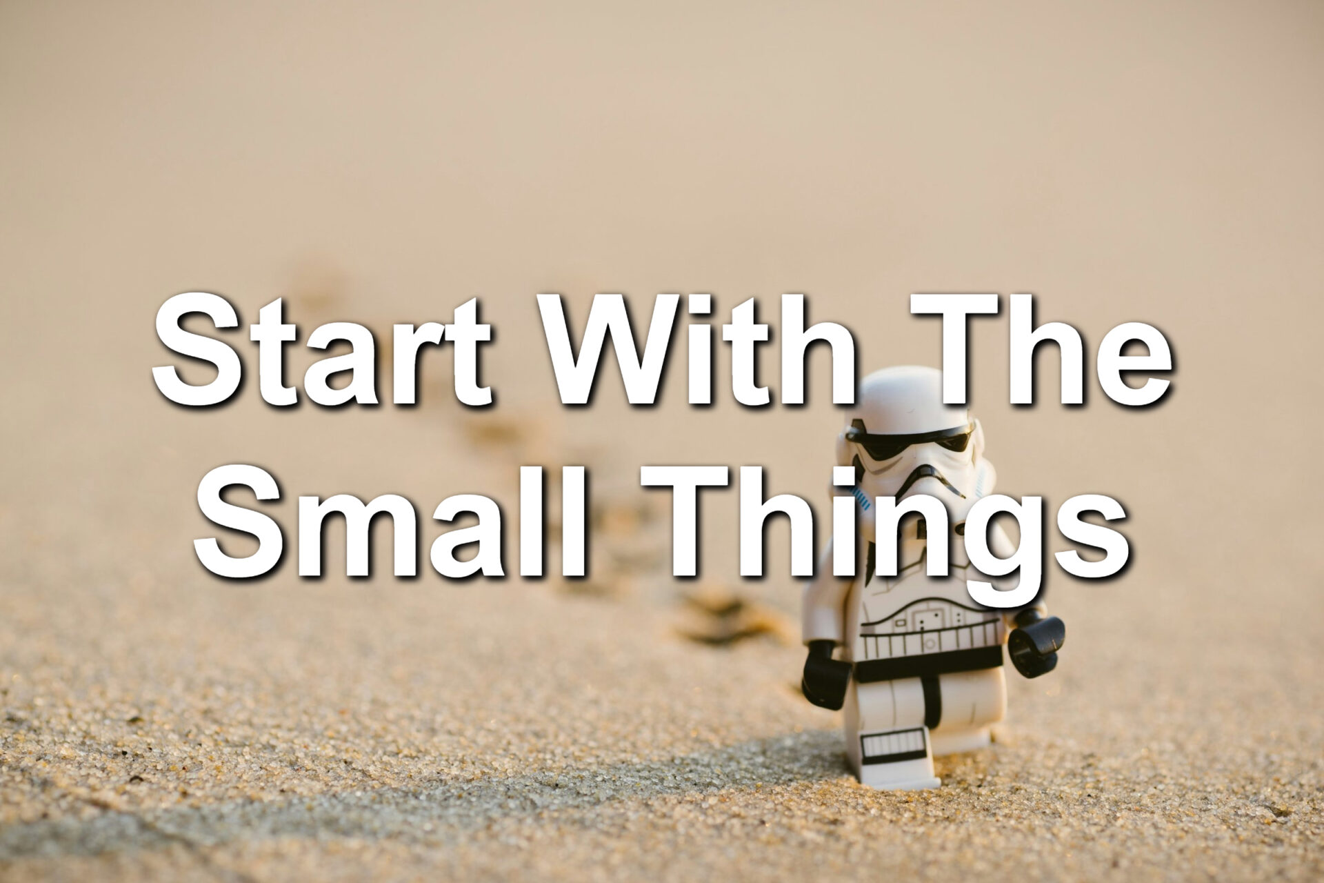 A Lego Stormtrooper from Star Wars walking through the sand