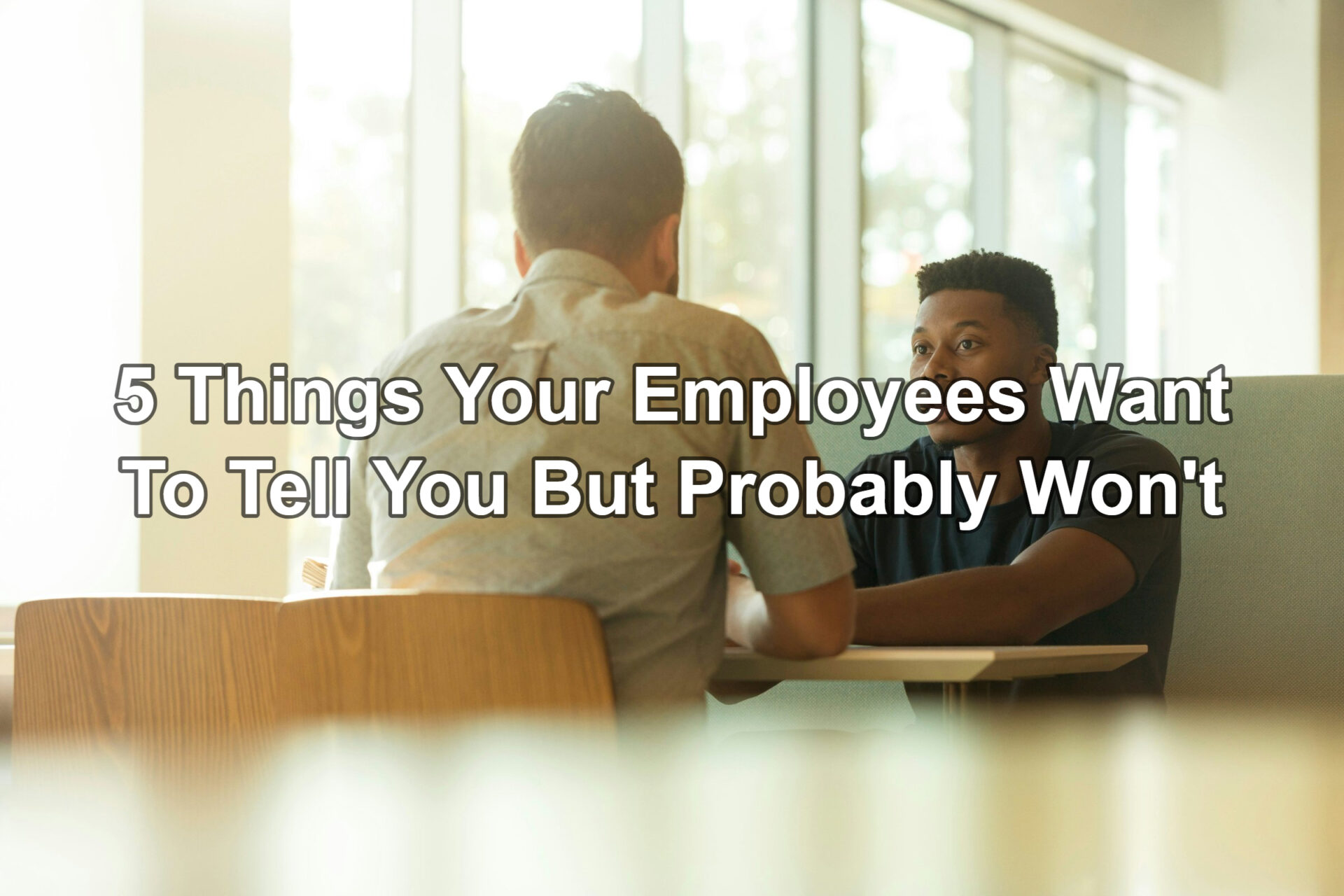 Two people sitting down, talking.