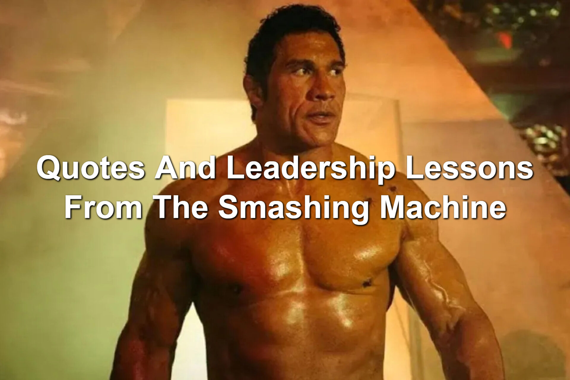 Scene from The Smashing Machine. Mark Kerr, a shirt-less machine who is ripped, is walking out of an entrance with smoke around him.