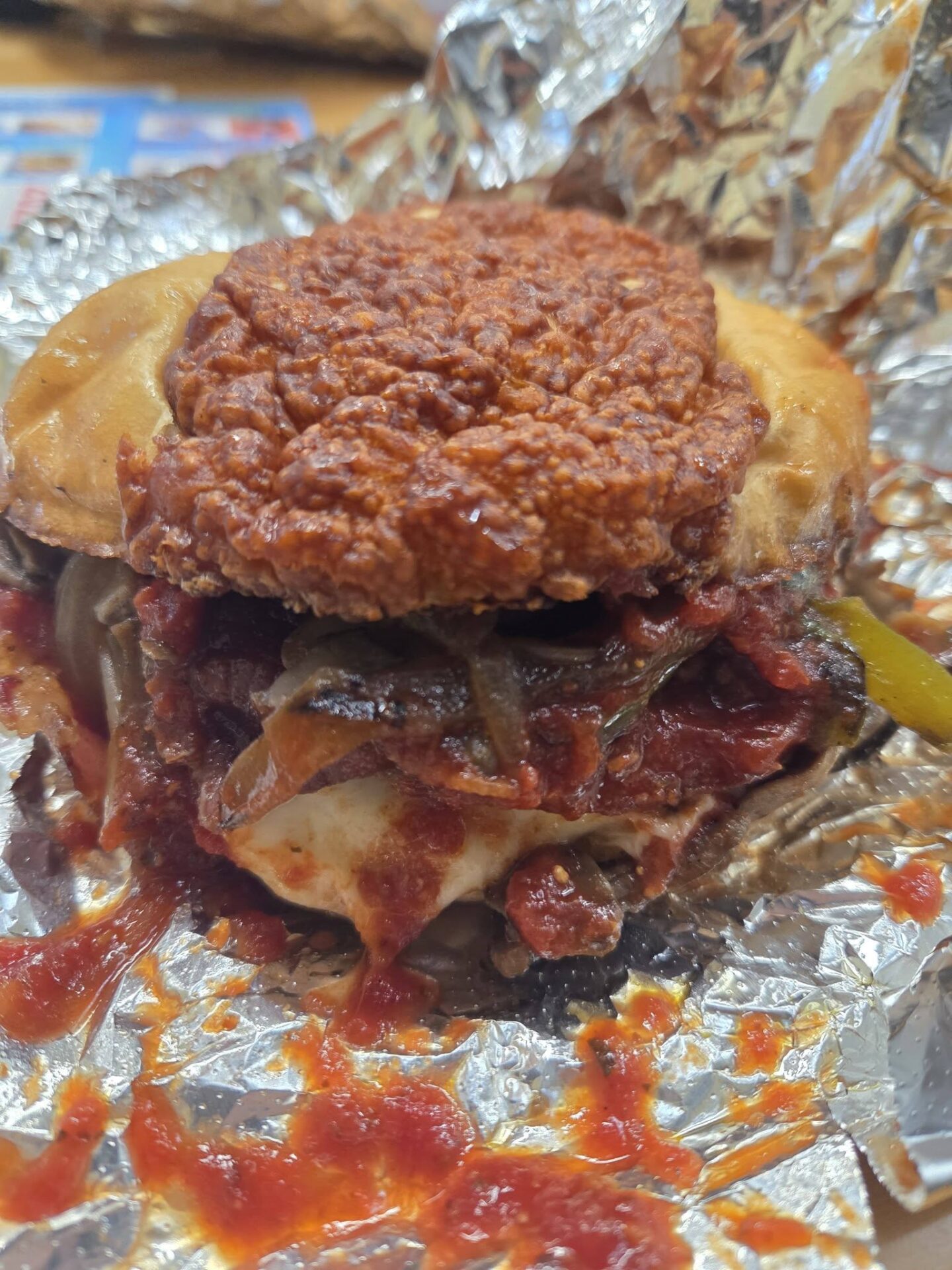 A burger that has pizza toppings